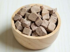 Small diced pieces of freeze-dried chicken liver, preserved for use as pet treats